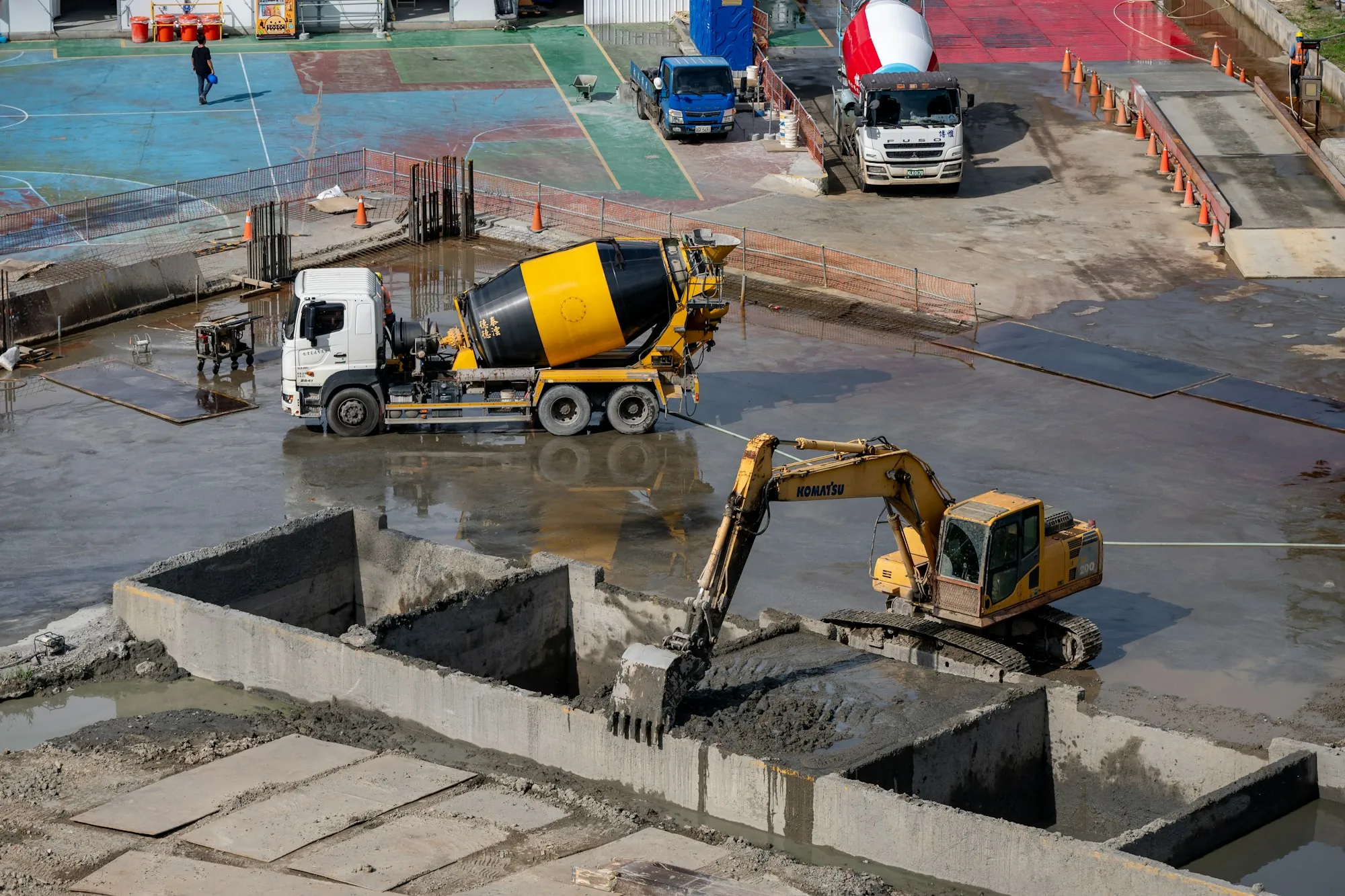 Mixer truck and excavator on a concrete job site